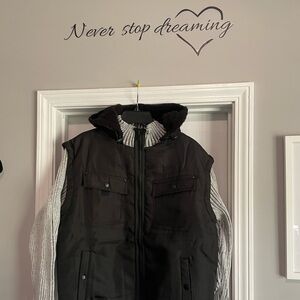 Men Black jacket with Light grey sleeves with a black hoodie.